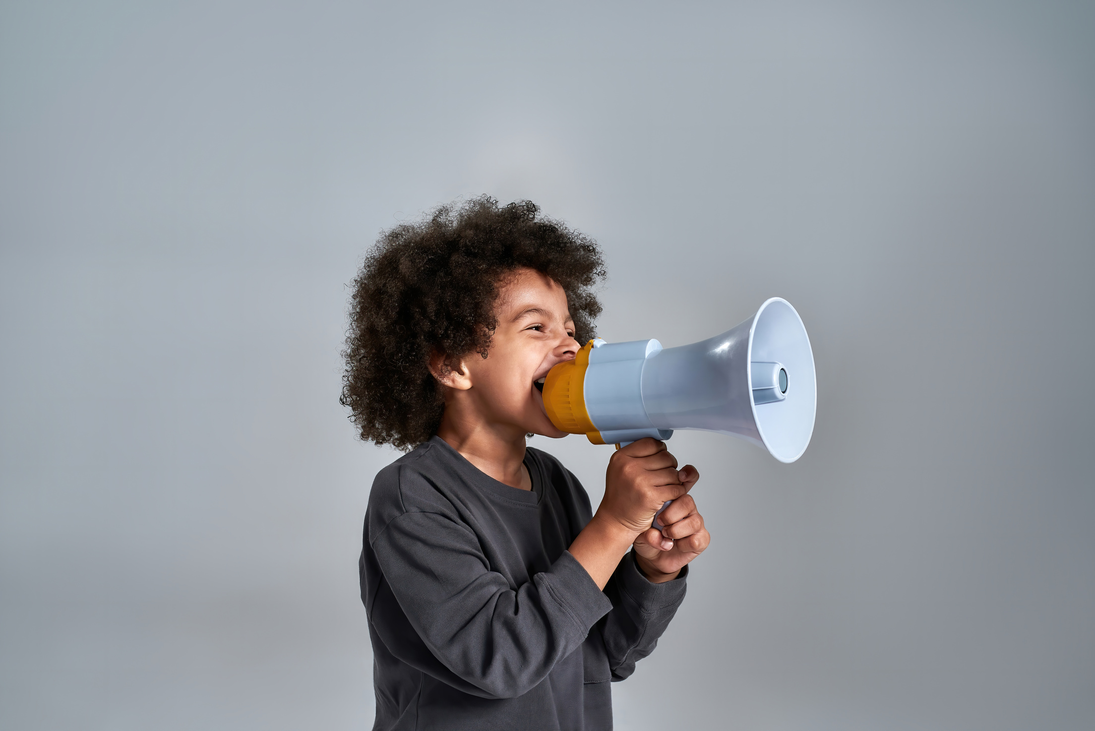 Little african american kid talking into megaphone